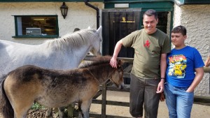 Dad and I stand with the Inn's horses.