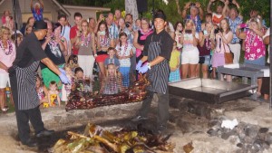 Them getting the pig out of the pit oven.